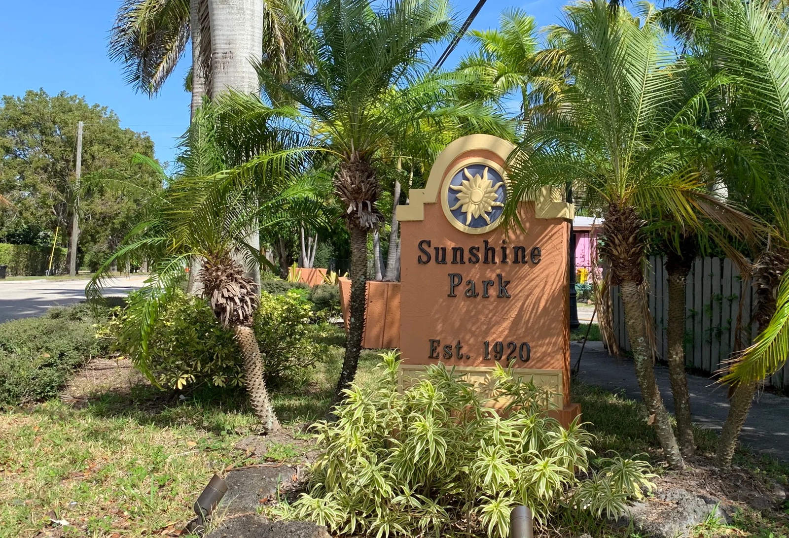 Sunshine Park neighborhood entrance sign among palm trees in West Palm Beach