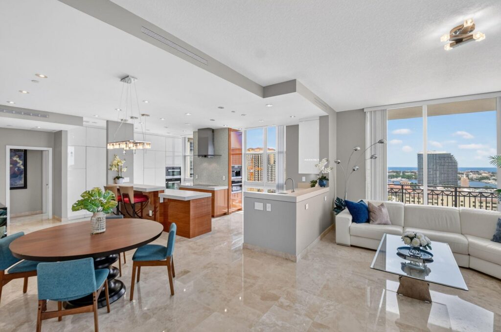Open-plan living, dining and kitchen area in CityPlace South Tower Unit LPH-23 at 550 Okeechobee Blvd, West Palm Beach, with floor-to-ceiling windows overlooking the city